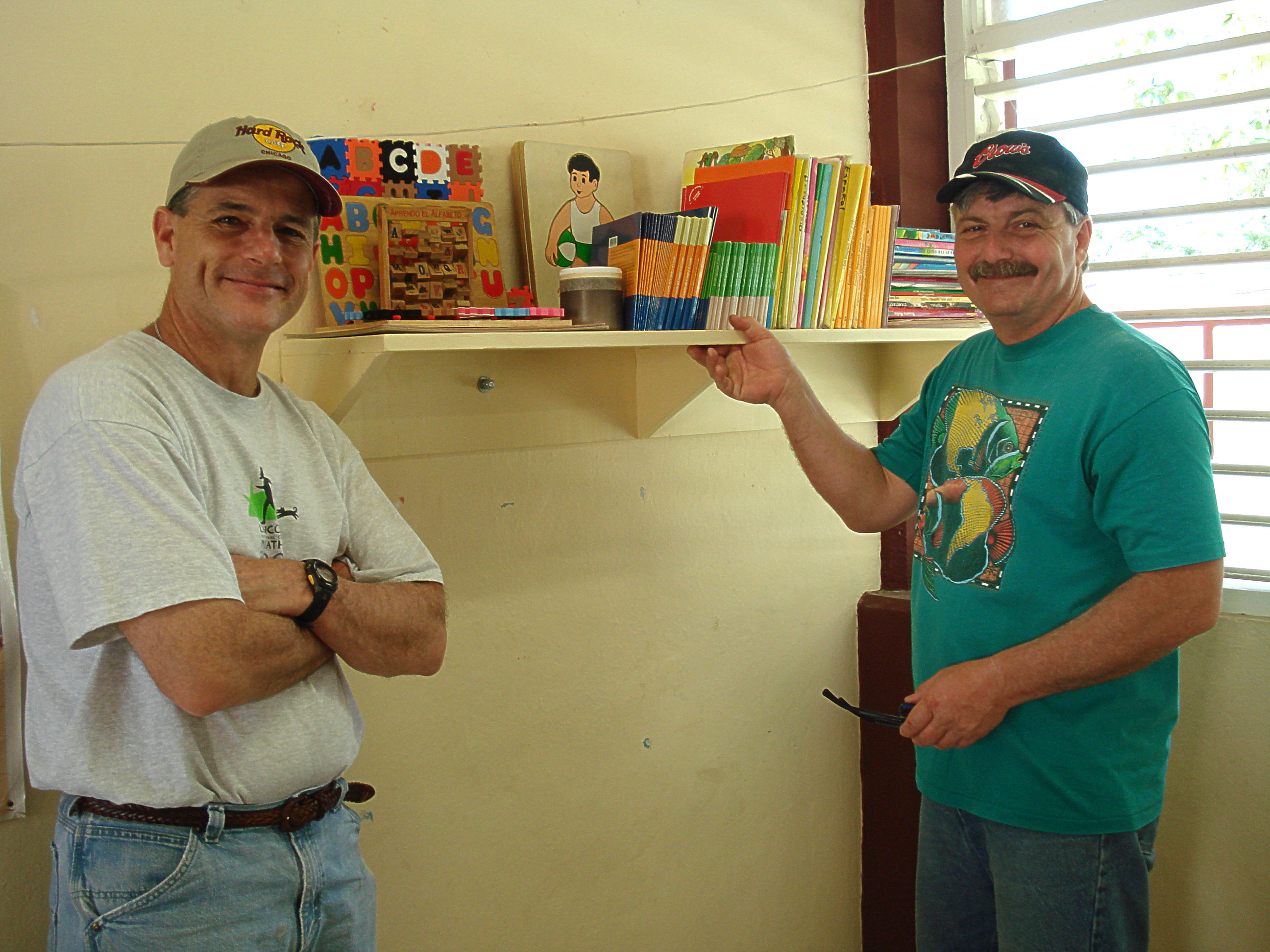 Jay and Gary install shelves for teaching materials at CAM School