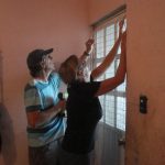 David and Shelley install window security mesh.