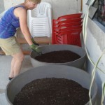 Karen puts soil into the Epcot planters.