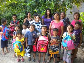  Children in Jose's family receiving their backpacks