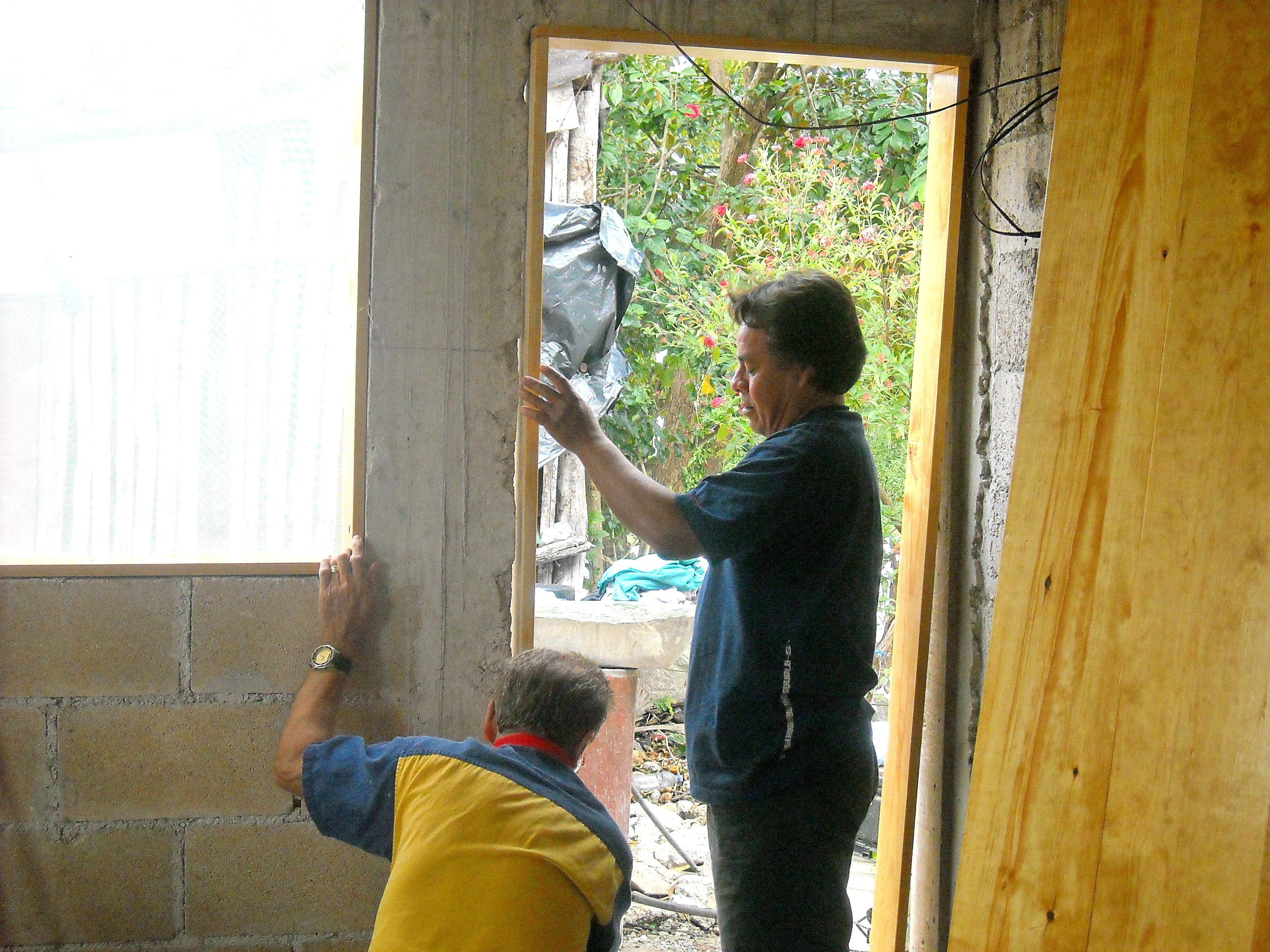 Ray and Ramiro install the door frame for Jose’s family