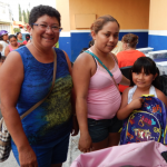 Local volunteer Maria (left) helped identify families in need of school supplies..
